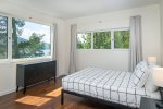 Bedroom 2 offers a queen sized bed, adjoining ensuite & incredible lake views.